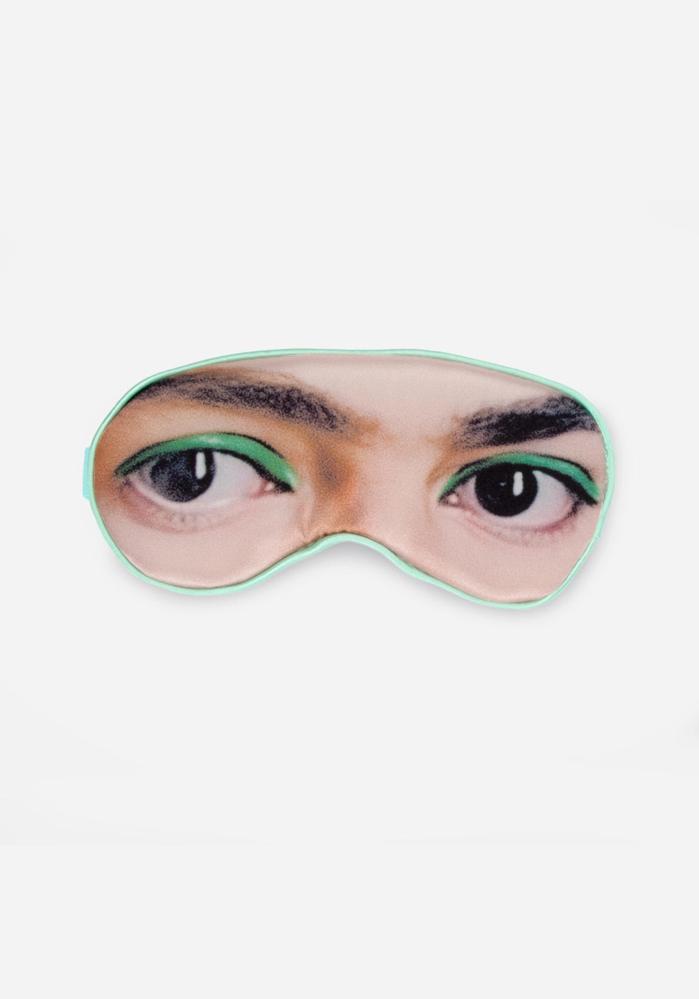 Ögonmask med tryck av Frida Kahlos mörka ögon med grön eyeliner och kraftiga ögonbryn, kantad med mintgrönt band.