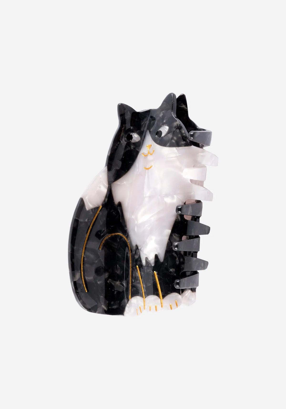 Hårklämma formad som en sittande svartvit katt i marmorerad acetat med guldfärgade detaljer, från Coucou Suzette