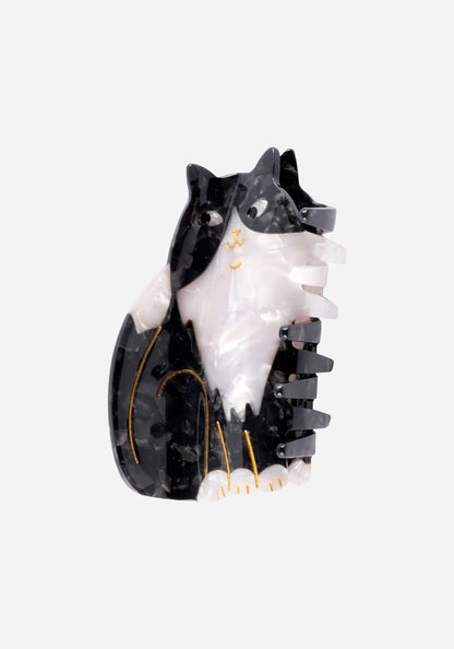Hårklämma formad som en sittande svartvit katt i marmorerad acetat med guldfärgade detaljer, från Coucou Suzette